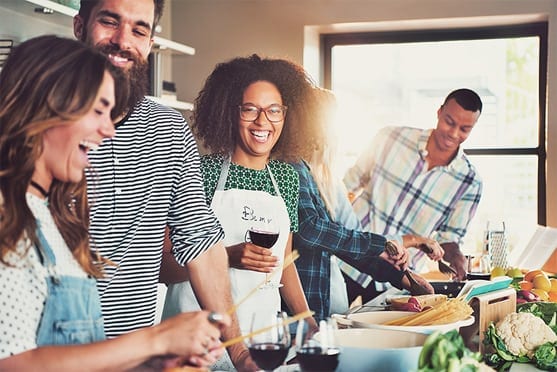 A group of people eat dinner and drink together